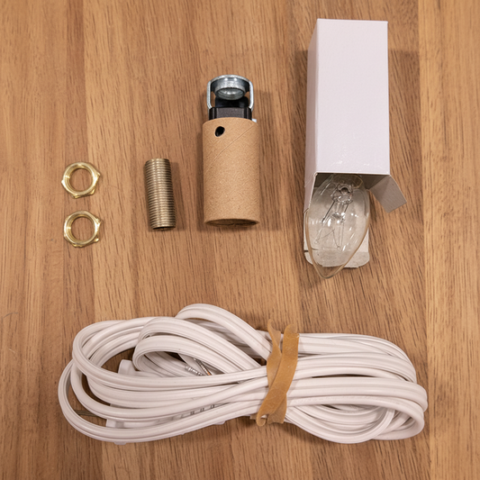 Light fixture components including a bulb, wiring, and connectors on a blue background